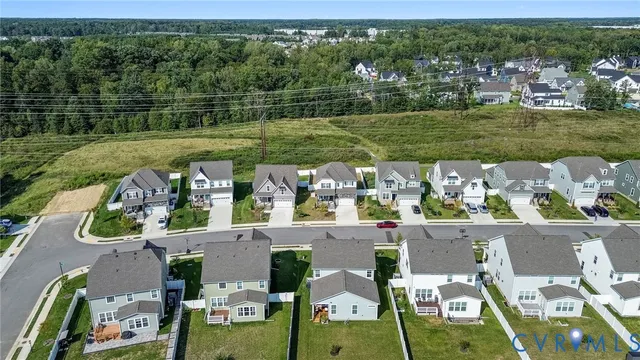 an aerial view of a house with a big yard