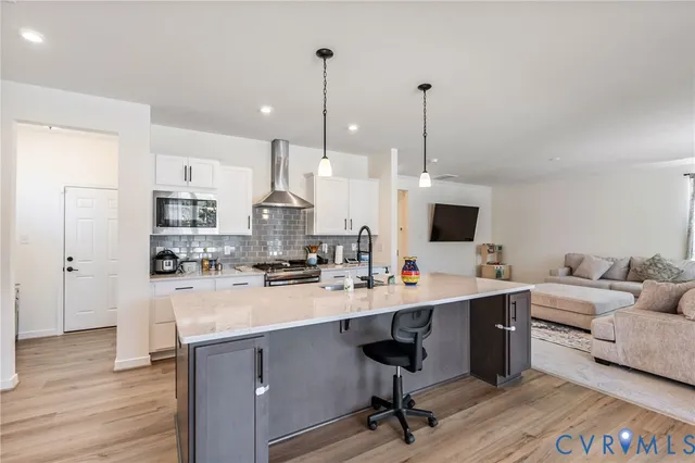 a view of a room with wooden floor and windows