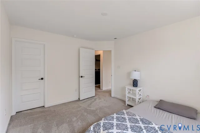 a open kitchen with stainless steel appliances granite countertop a stove a sink dishwasher a refrigerator and white cabinets with wooden floor