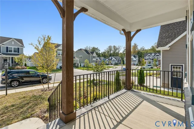 a view of a balcony with chairs and wooden fence