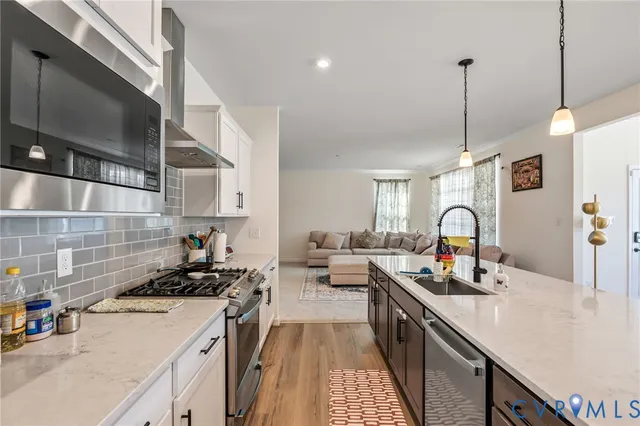 a kitchen with sink a stove and cabinets