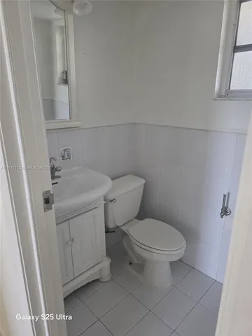 a white toilet sitting next to a bathroom sink