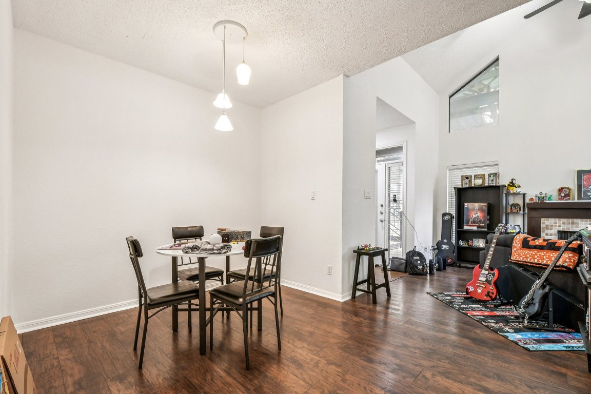 1910 Robbins Place, Unit 301 Austin, TX 78705 - Photo 12 of 29 a view of a dining room with furniture and wooden floor