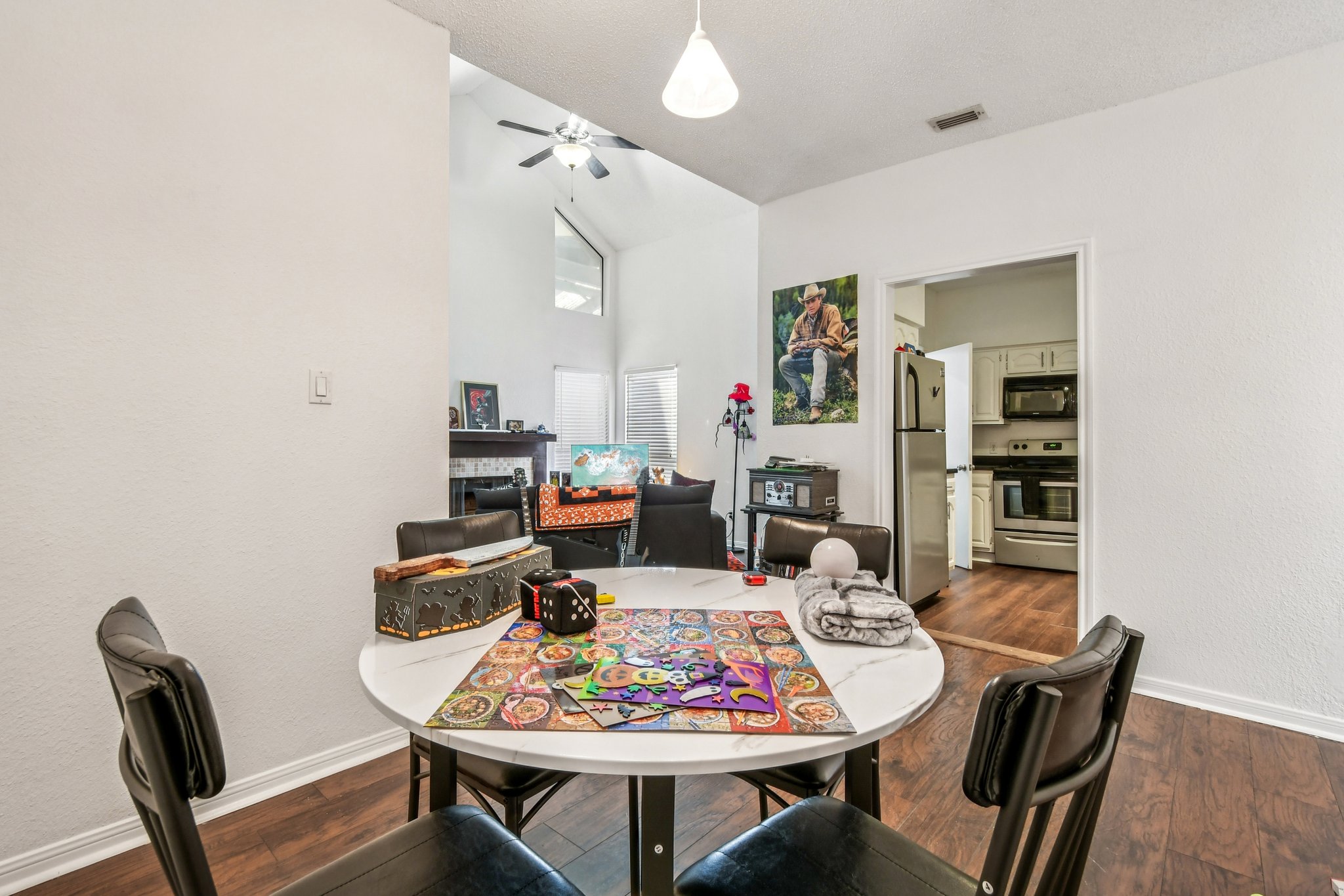 1910 Robbins Place, Unit 301 Austin, TX 78705 - Photo 12 of 29 a view of a dining room with furniture and wooden floor