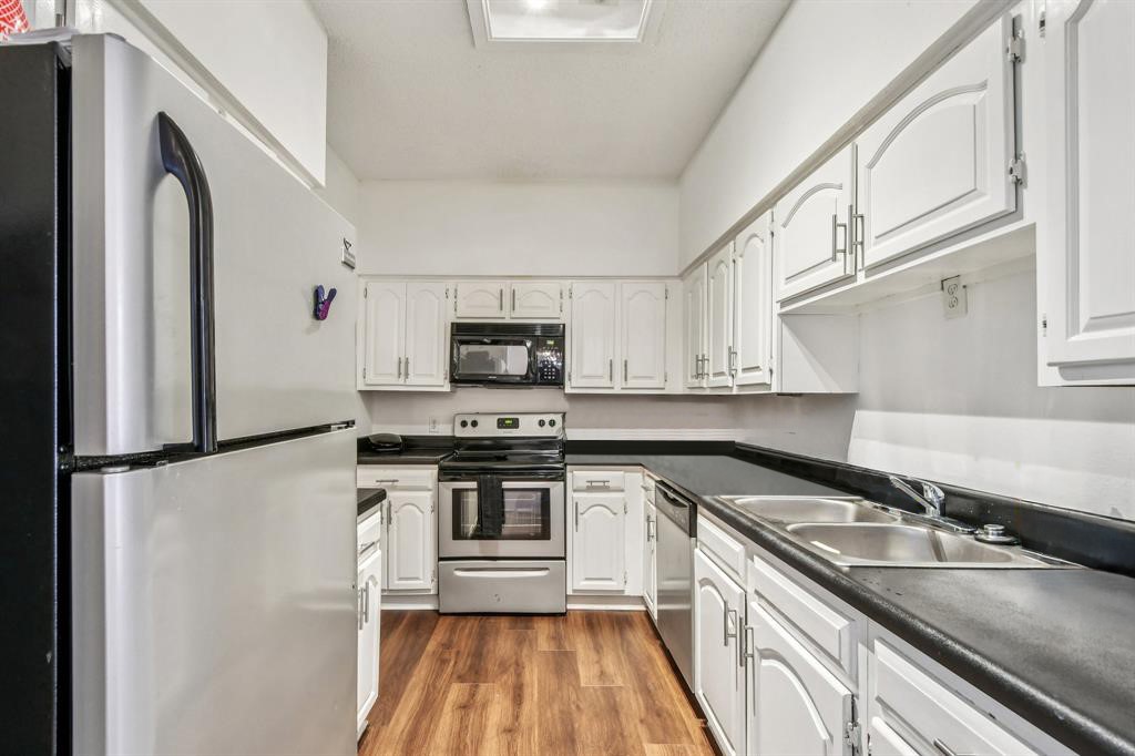 1910 Robbins Place, Unit 301 Austin, TX 78705 - Photo 13 of 29 a kitchen with stainless steel appliances granite countertop a sink stove and refrigerator