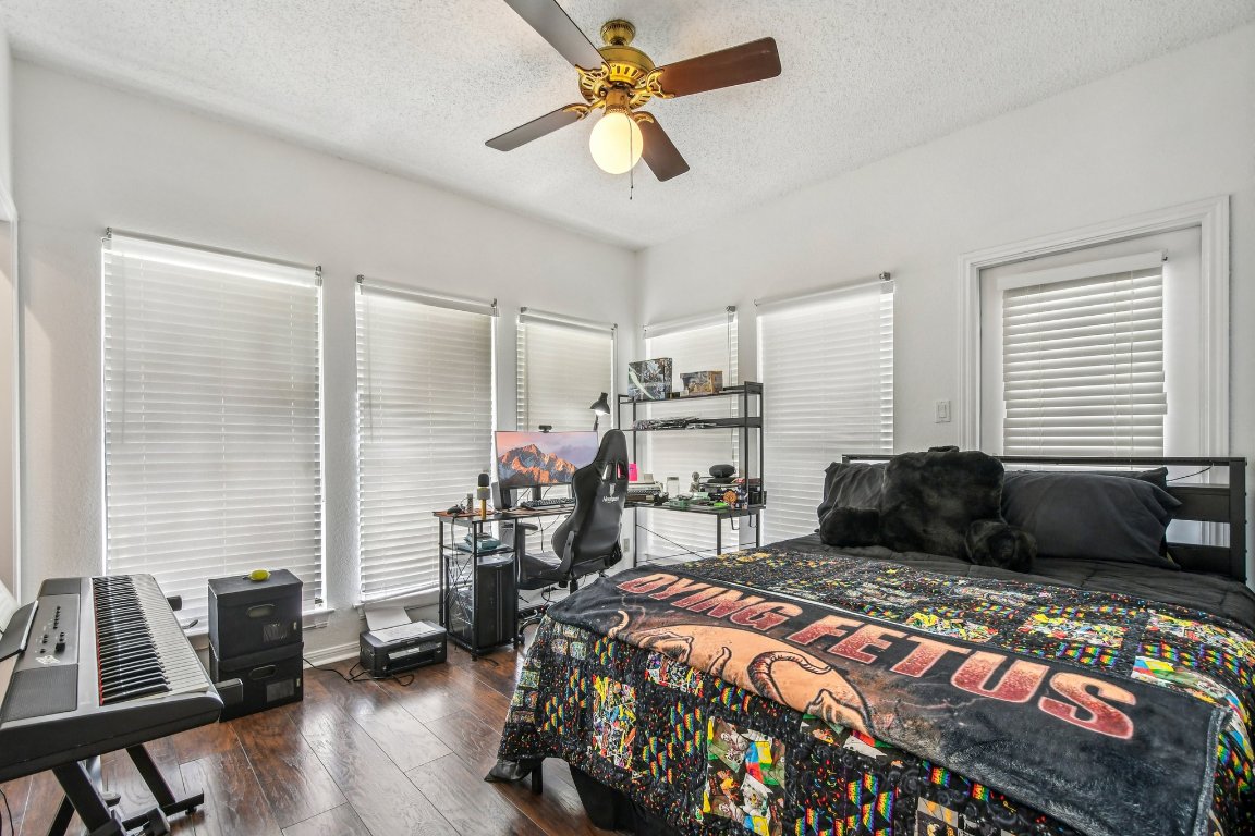 1910 Robbins Place, Unit 301 Austin, TX 78705 - Photo 16 of 29 a bedroom with a bed a couch and a window