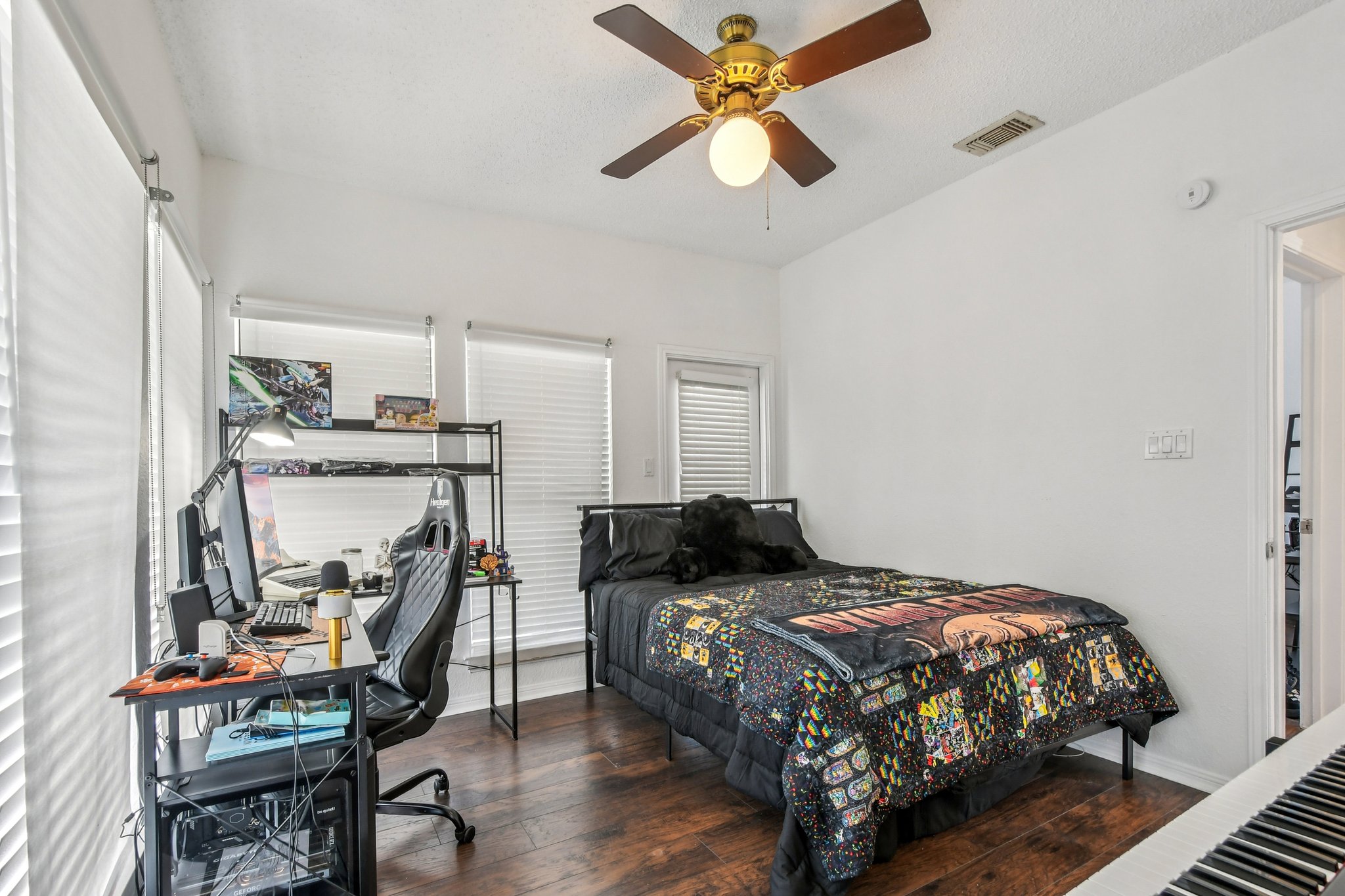 1910 Robbins Place, Unit 301 Austin, TX 78705 - Photo 18 of 29 a bedroom with a bed a chair and a chandelier
