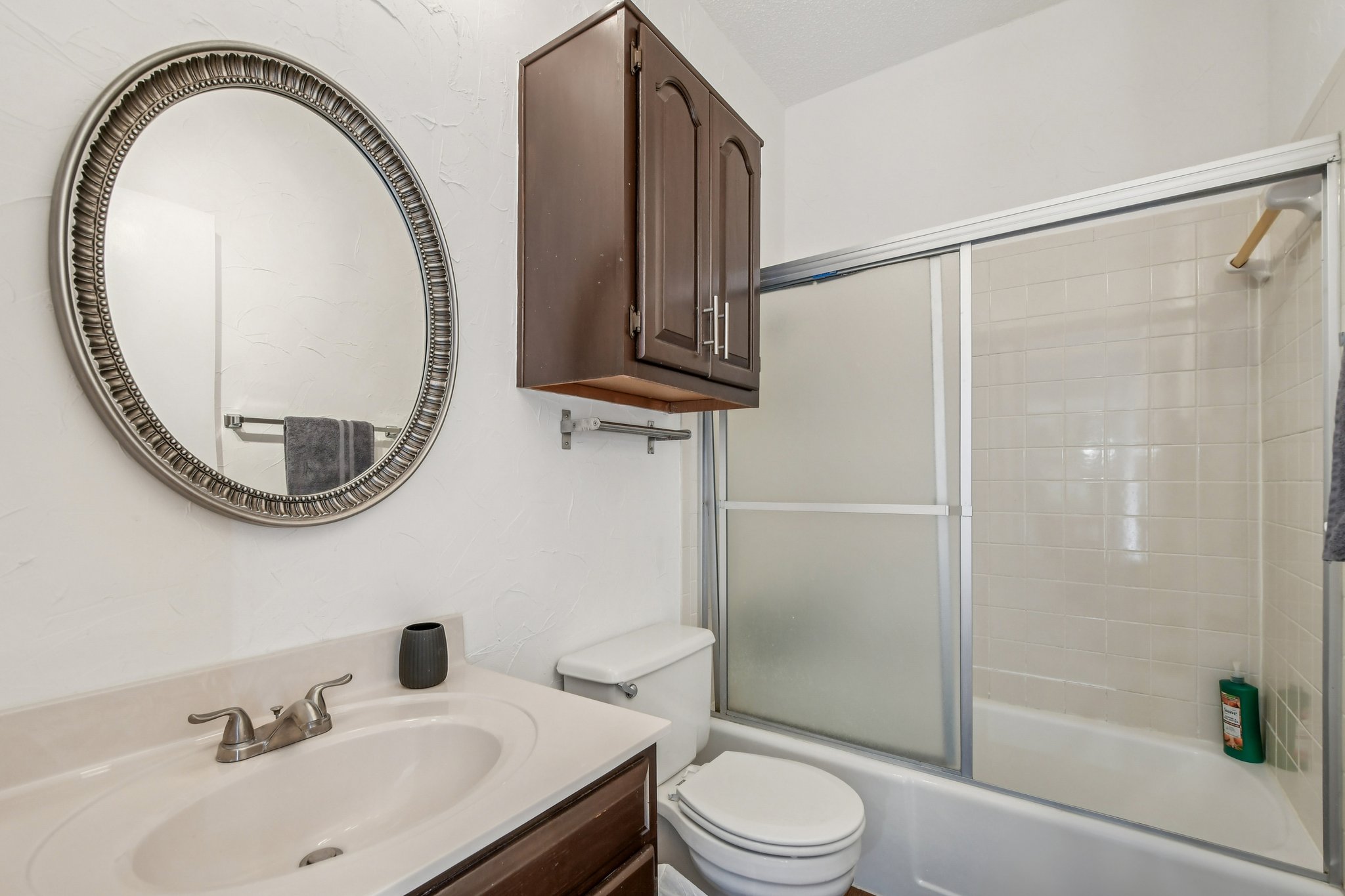 1910 Robbins Place, Unit 301 Austin, TX 78705 - Photo 19 of 29 a bathroom with a sink a toilet and a mirror