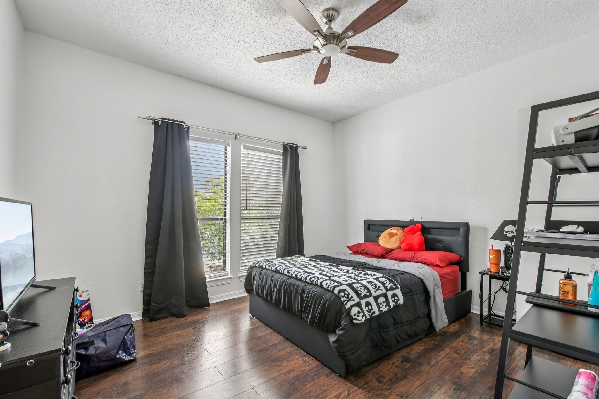 1910 Robbins Place, Unit 301 Austin, TX 78705 - Photo 20 of 29 a bedroom with a bed painting on wall and a window