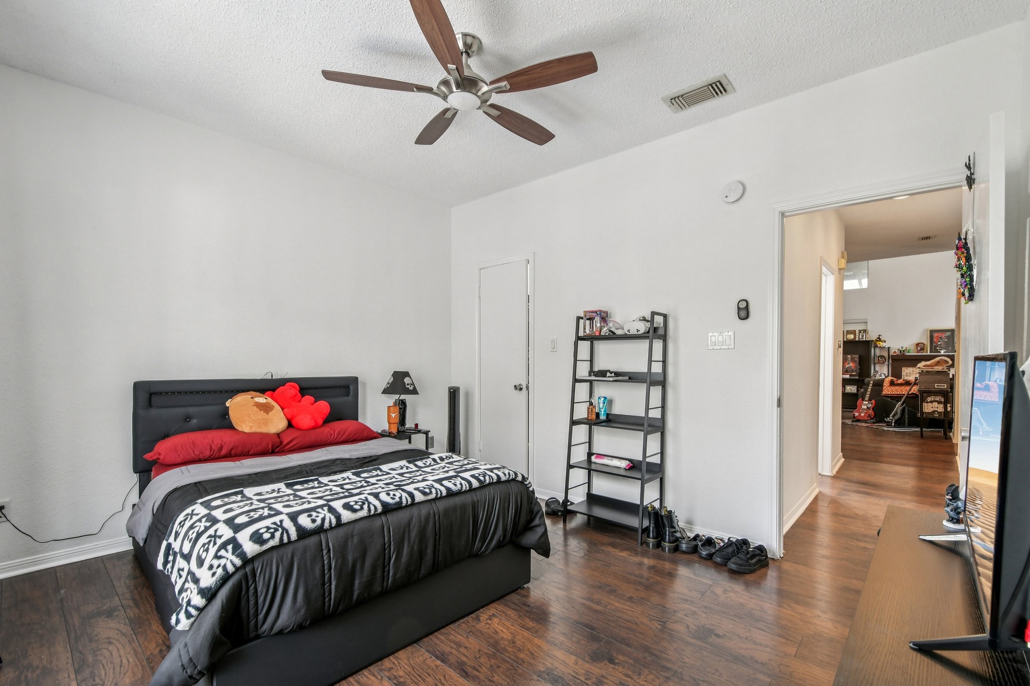 1910 Robbins Place, Unit 301 Austin, TX 78705 - Photo 21 of 29 a bedroom with a bed and a book shelf