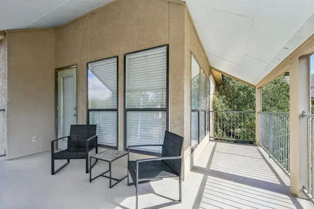 a view of a living room with a large window and a chandelier