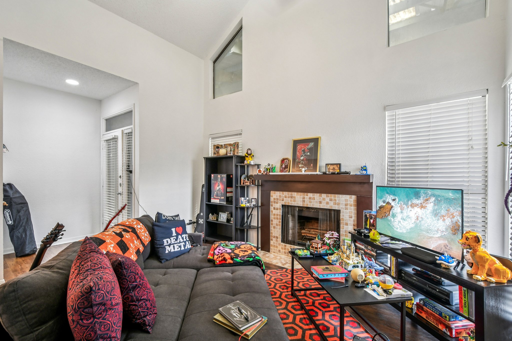 1910 Robbins Place, Unit 301 Austin, TX 78705 - Photo 7 of 29 a living room with furniture a fireplace and a flat screen tv