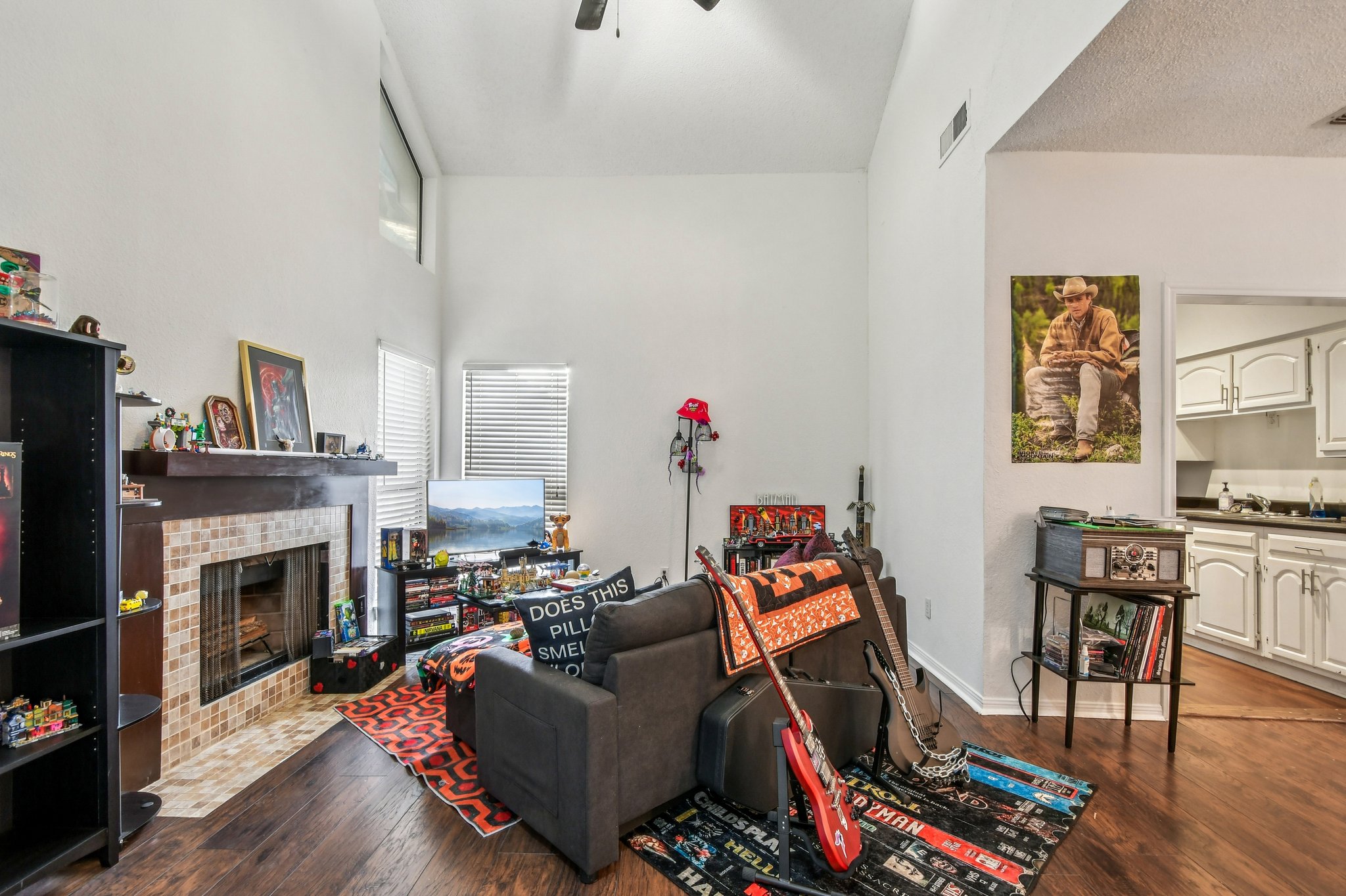 1910 Robbins Place, Unit 301 Austin, TX 78705 - Photo 10 of 29 a living room with furniture a fireplace and a flat screen tv