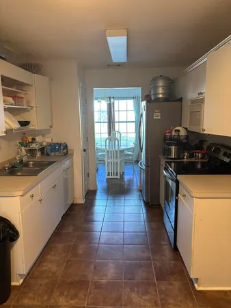 a kitchen with a sink a stove and cabinets