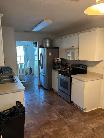 a kitchen with a stove and a refrigerator