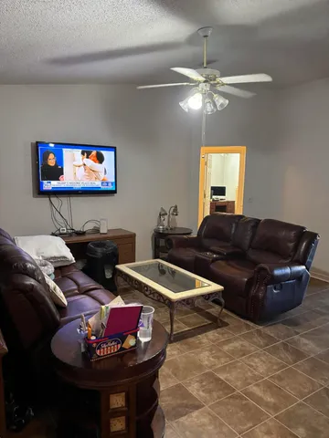 a living room with furniture and a chandelier