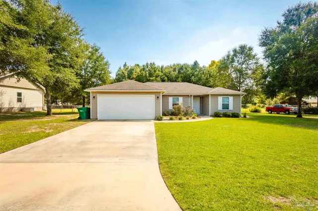a front view of house with yard and swimming pool