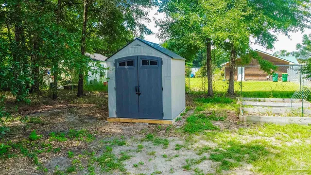 a view of backyard with plants and outdoor seating