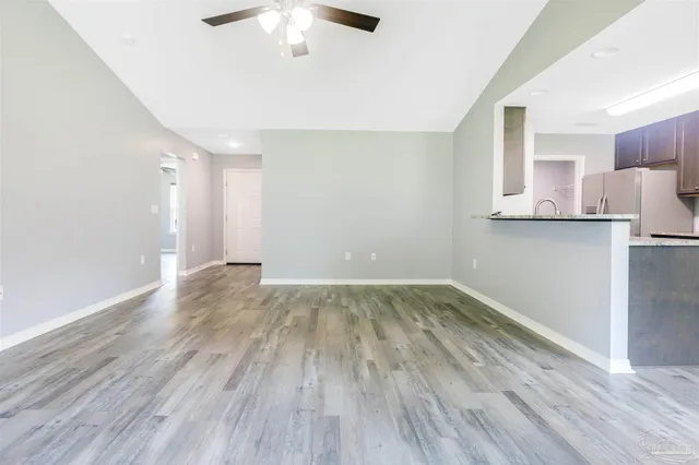 a view of a kitchen with a sink and a refrigerator
