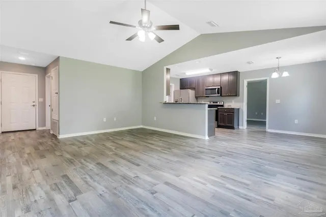 a view of a kitchen with dishwasher and wooden floor