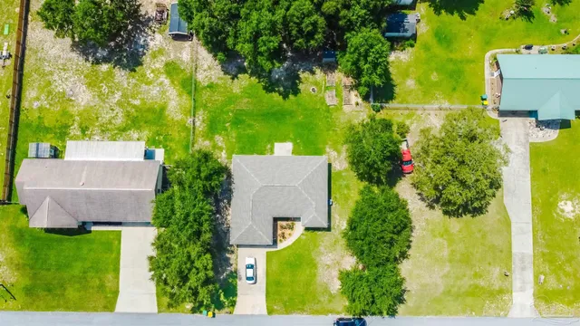 an aerial view of a house with a yard basket ball court and outdoor seating
