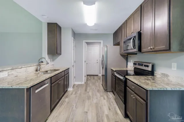 a kitchen with a sink stove and microwave