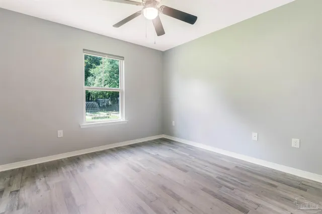 a view of a room with wooden floor and window