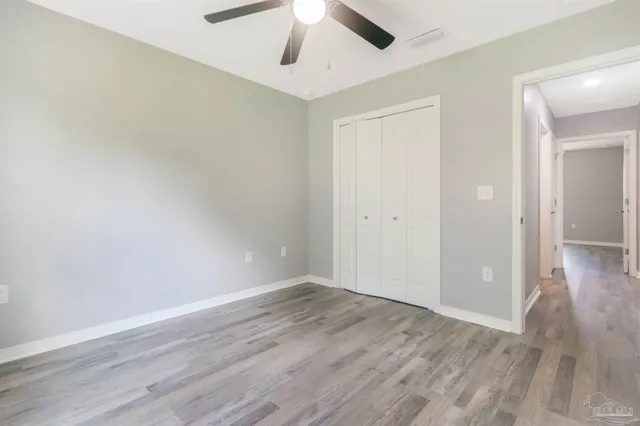 an empty room with wooden floor