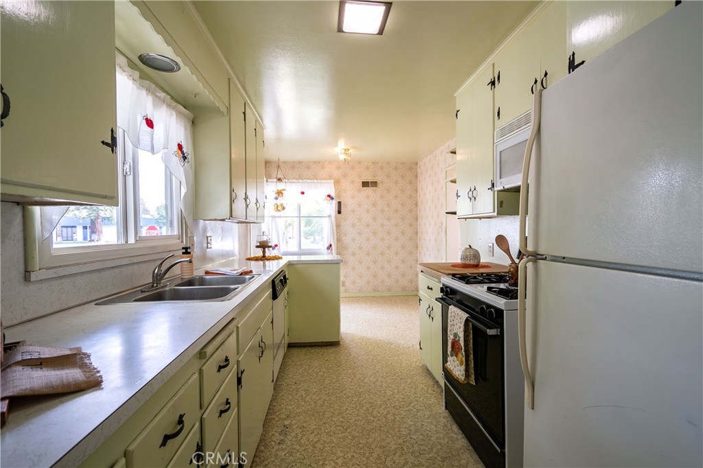 404 2nd Street Orland, CA 95963 - Photo 13 of 40 a kitchen with stainless steel appliances granite countertop a sink stove and refrigerator