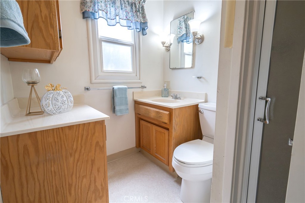 404 2nd Street Orland, CA 95963 - Photo 21 of 40 a bathroom with a toilet sink and mirror