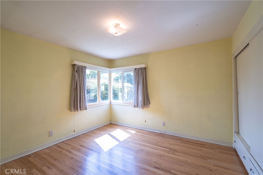 404 2nd Street Orland, CA 95963 - Photo 23 of 40 an empty room with wooden floor and windows