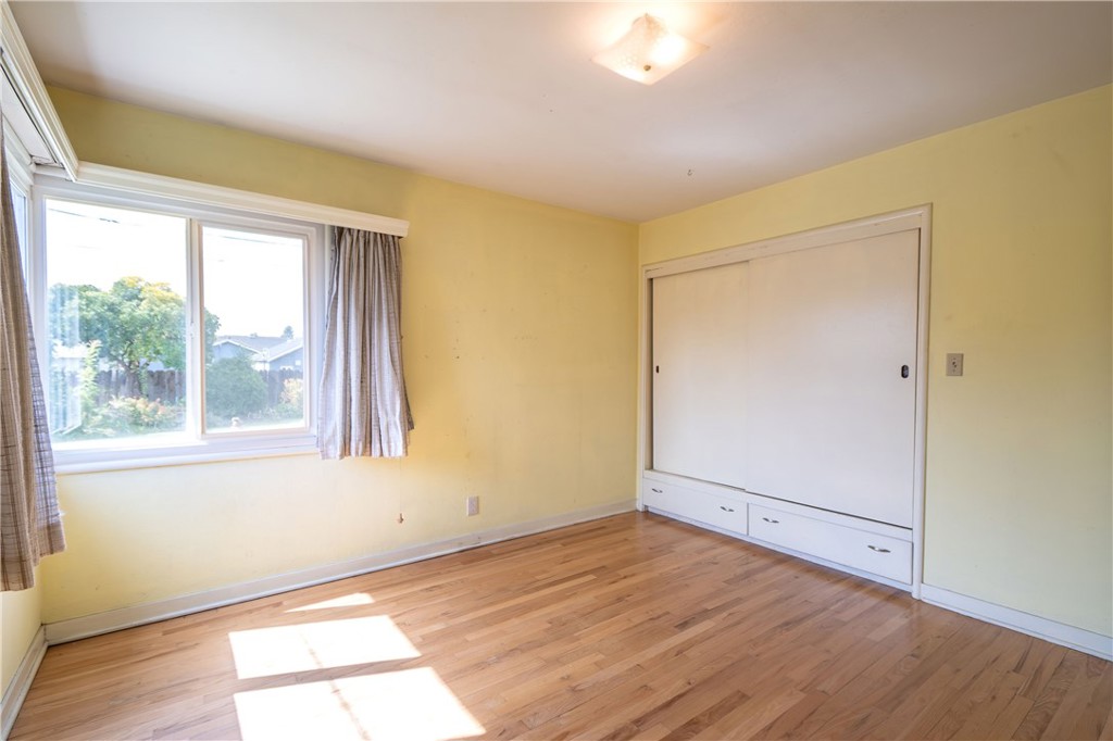 404 2nd Street Orland, CA 95963 - Photo 24 of 40 an empty room with wooden floor and windows