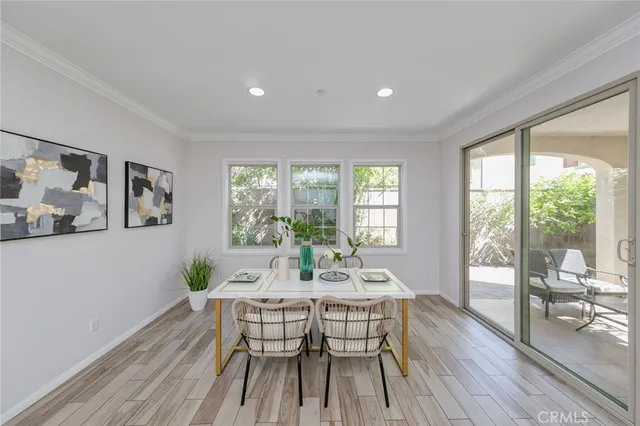 a dining room with furniture window and wooden floor