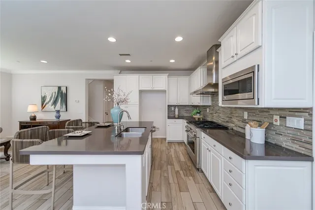 a kitchen with stainless steel appliances granite countertop a sink stove microwave and cabinets