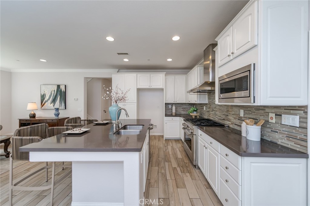 177 Firefly Irvine, CA 92618 - Photo 21 of 22 a kitchen with stainless steel appliances granite countertop a sink stove microwave and cabinets
