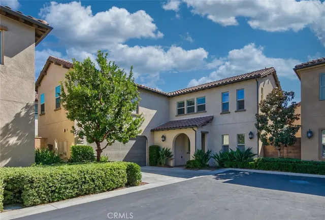 a front view of house with a garden