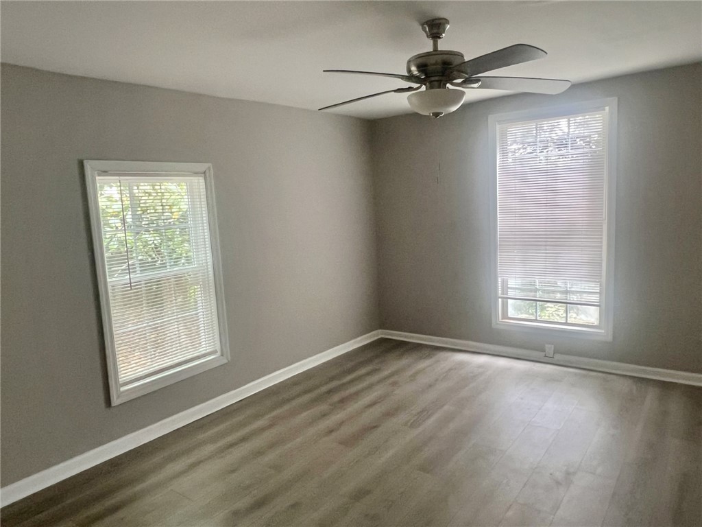 301 Hammett Street Honea Path, SC 29654 - Photo 8 of 14 This naturally illuminated bedroom offers durable flooring and a ceiling fan for optimal comfort.