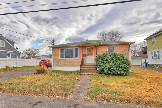 a view of a house with a yard and garage