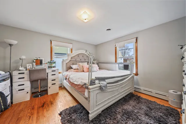 a bed sitting in a bedroom next to a window