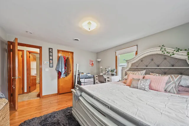 a bed sitting in a bedroom next to a window