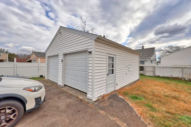 a view of a house with a big yard and large trees