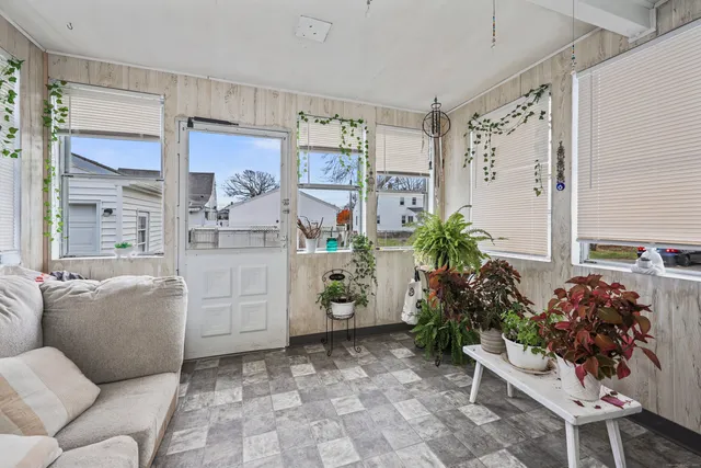 a living room with furniture and flowers