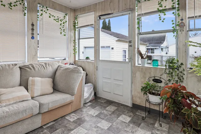 a living room with furniture and a potted plant