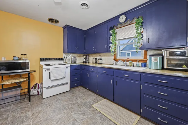 a kitchen with a sink and wooden cabinets
