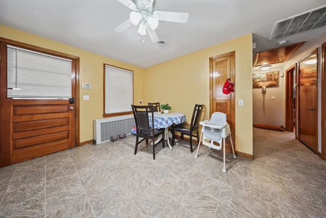 a view of a dining room with furniture and a chandelier