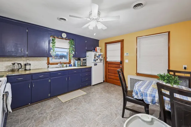 a kitchen with granite countertop wooden cabinets and stainless steel appliances