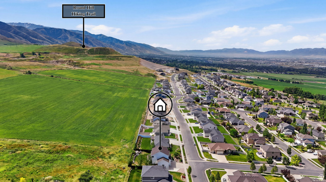 338 Windy Rdg Drive Smithfield, UT 84335 - Photo 63 of 63 Aerial perspective showcasing a residential development alongside expansive green fields and distant mountains