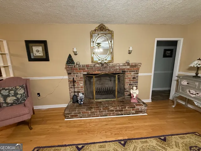 a living room with fireplace furniture and a fireplace