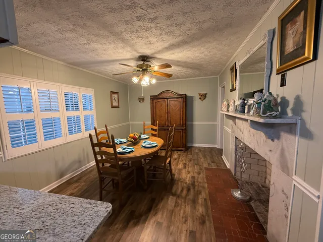 a view of a dining room with furniture and a chandelier