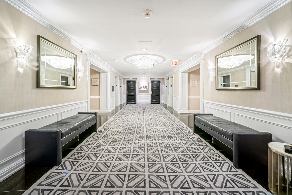 160 Central Park South, Unit 1005 Manhattan, NY 10019 - Photo 19 of 21 a view of a hallway with wooden floor and staircase